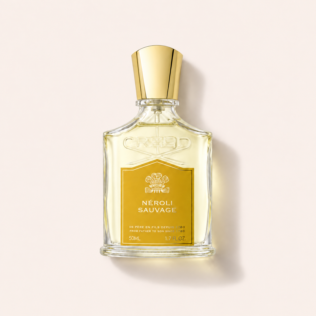 Průhledný flakon parfémované vody Creed Neroli Sauvage EDP 50 ml se zlatým uzávěrem a etiketou – MrRizz