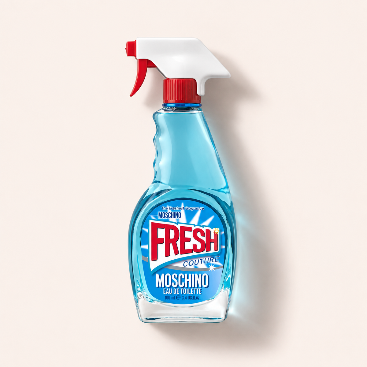 Flakon Moschino Fresh Couture EDT 100 ml na béžovém pozadí – MrRizz