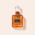 Juicy Couture Glistening Amber EDP 100 ml na béžovém pozadí – MrRizz
